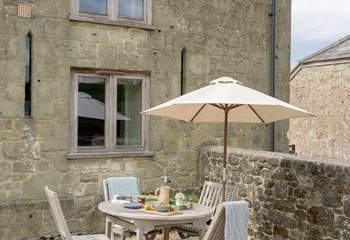 The pretty little outdoor seating area is tucked neatly in a sunny spot.
