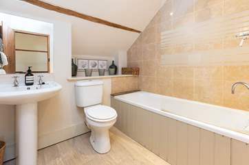 The family bathroom in Dairyman's Cottage is fresh and contemporary.