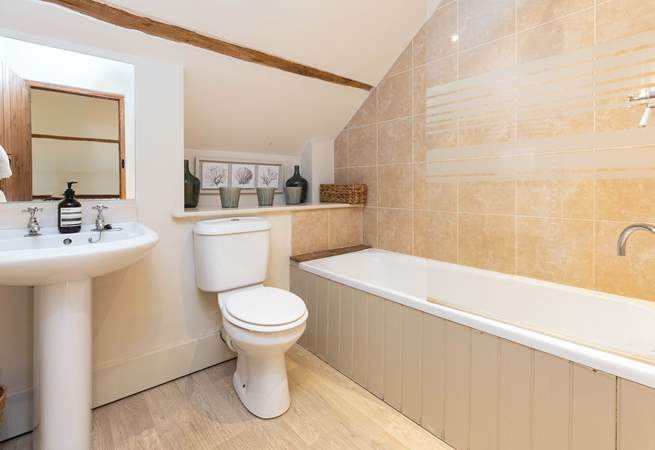 The family bathroom in Dairyman's Cottage is fresh and contemporary.