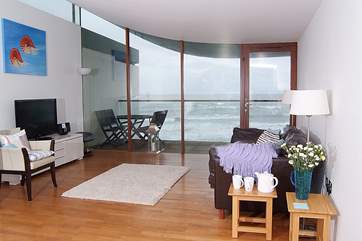 The living-area has a balcony and amazing sea views.