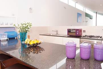 The sleek kitchen is extremely well-equipped. There is now a brand new electric hob, replacing the gas one shown in this image.