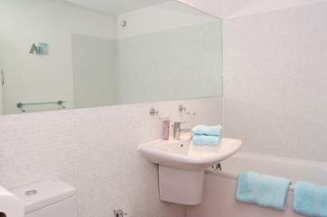 The master bedroom has a large en suite bathroom.