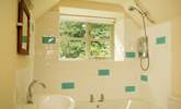 The pretty bathroom has room for a bath as well as the shower. - Thumbnail Image