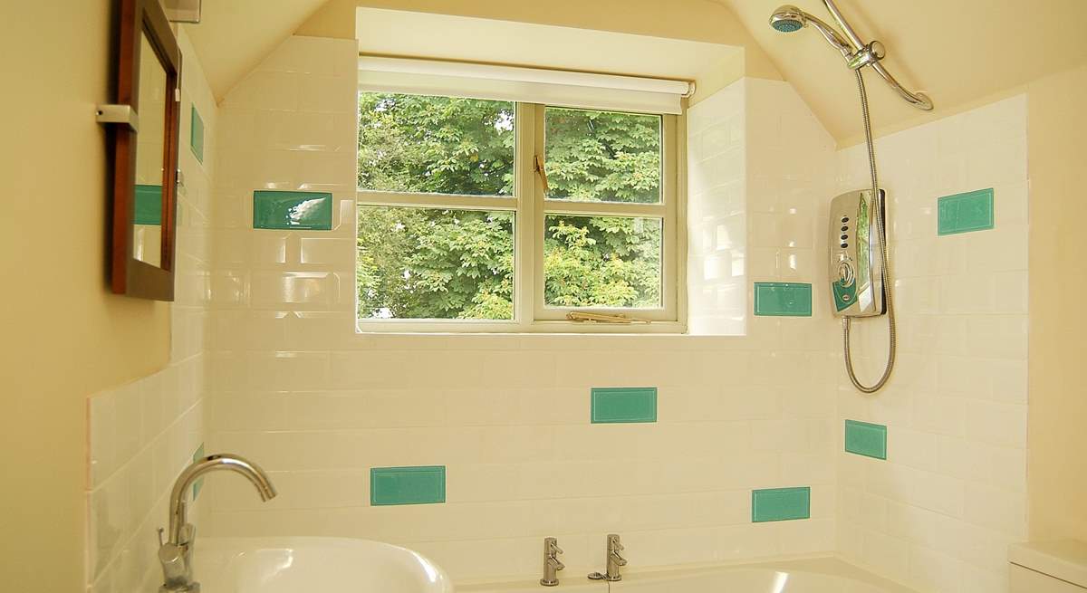 The pretty bathroom has room for a bath as well as the shower.