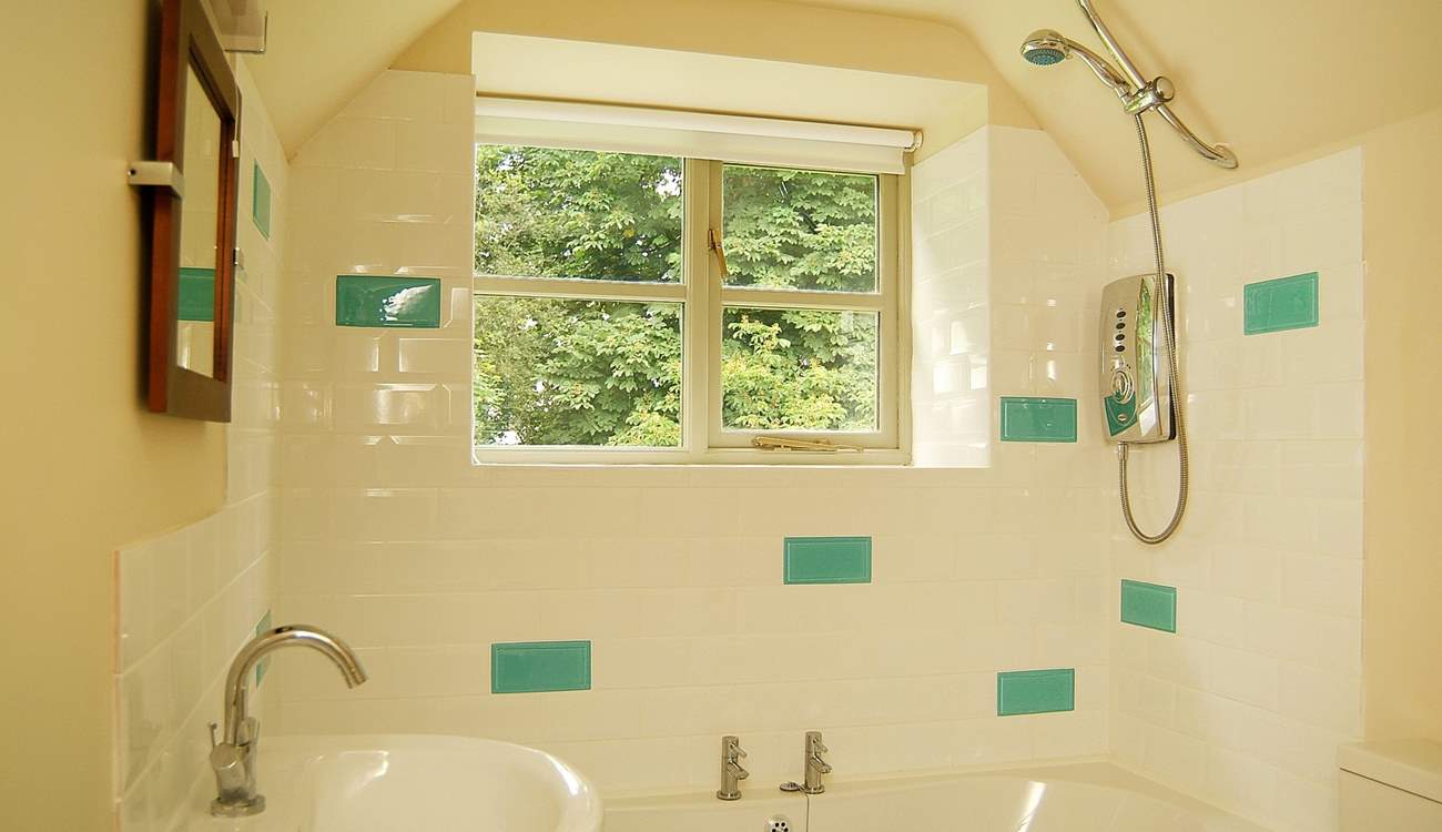 The pretty bathroom has room for a bath as well as the shower.