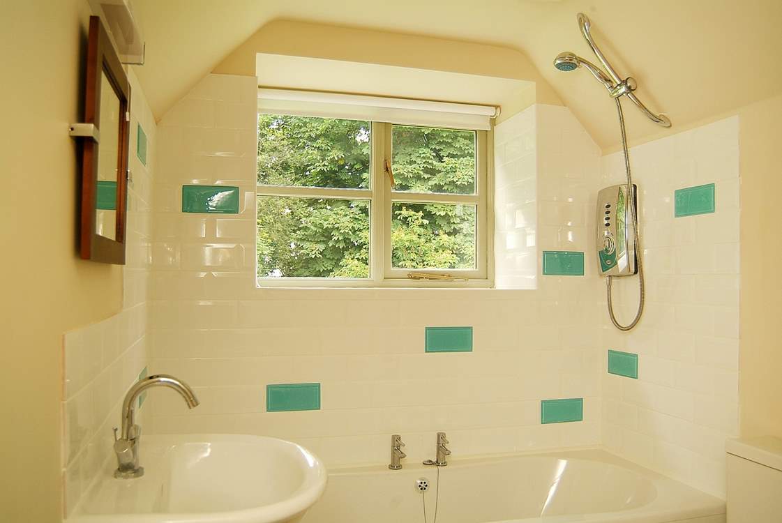The pretty bathroom has room for a bath as well as the shower.