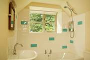 The pretty bathroom has room for a bath as well as the shower.