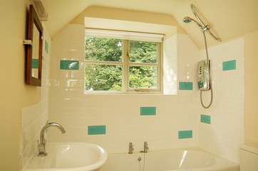 The pretty bathroom has room for a bath as well as the shower.