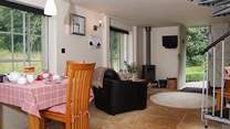 Looking across the living-area from the other direction. There is a wood-burning stove for cosy evenings in.