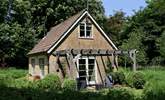 This is the meadow-side of The Pump House. There is a terrace beneath the pergola and not a house in sight. - Thumbnail Image