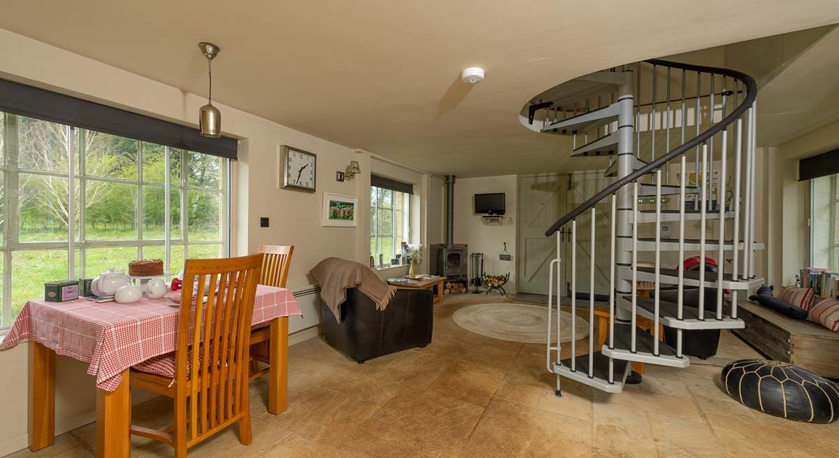 There is a spiral staircase leading up to the bedroom and bathroom.