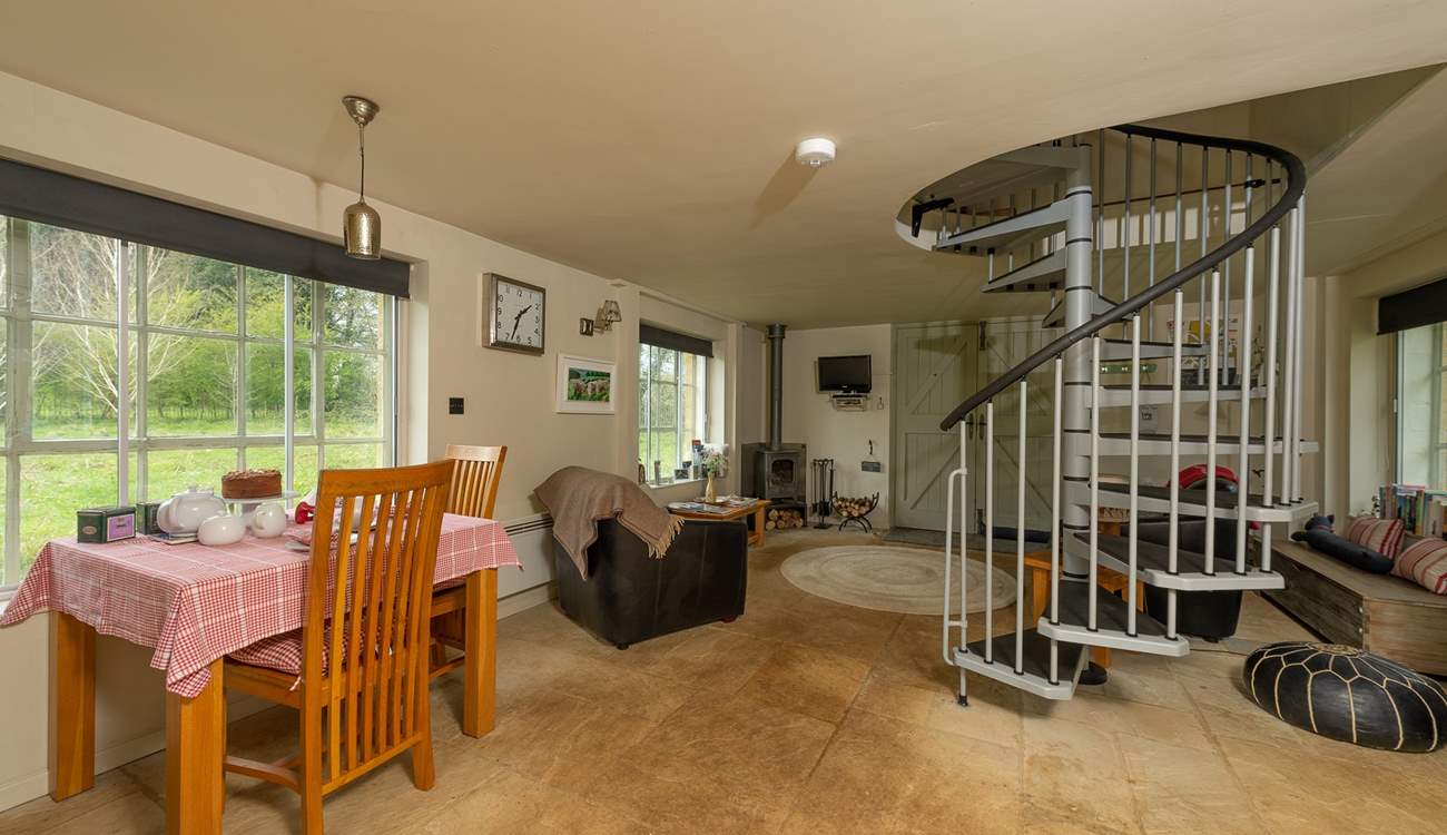 There is a spiral staircase leading up to the bedroom and bathroom.
