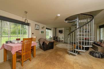 There is a spiral staircase leading up to the bedroom and bathroom.