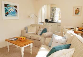 The open plan living-room is light and comfortably furnished.
