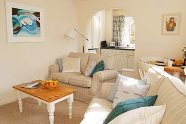 The open plan living-room is light and comfortably furnished.