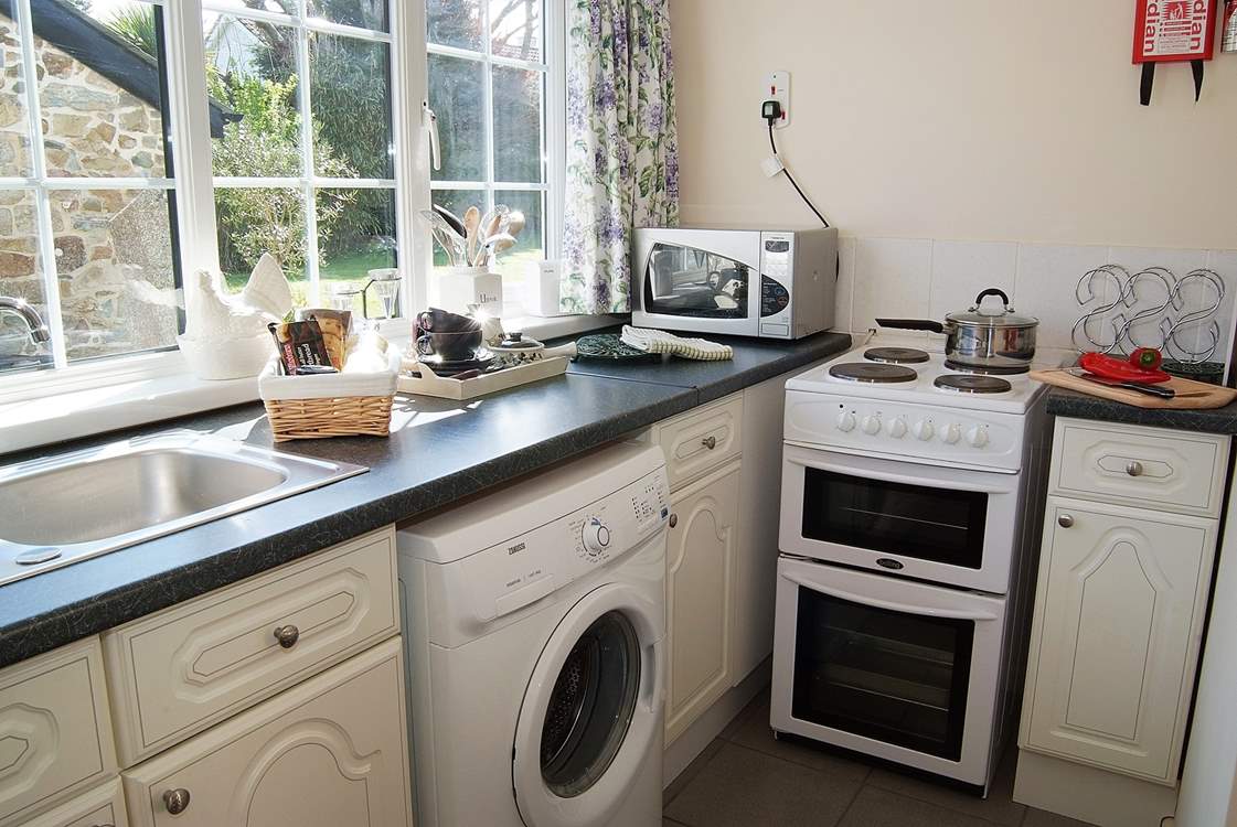 The cute kitchen has views over the beautifully maintained garden.