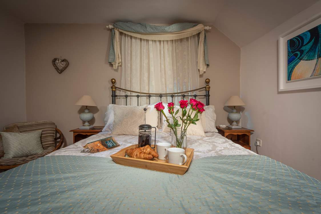 The spacious double bedroom has a king-size bed and gorgeous hand-made soft furnishings.