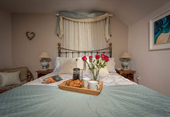 The spacious double bedroom has a king-size bed and gorgeous hand-made soft furnishings.