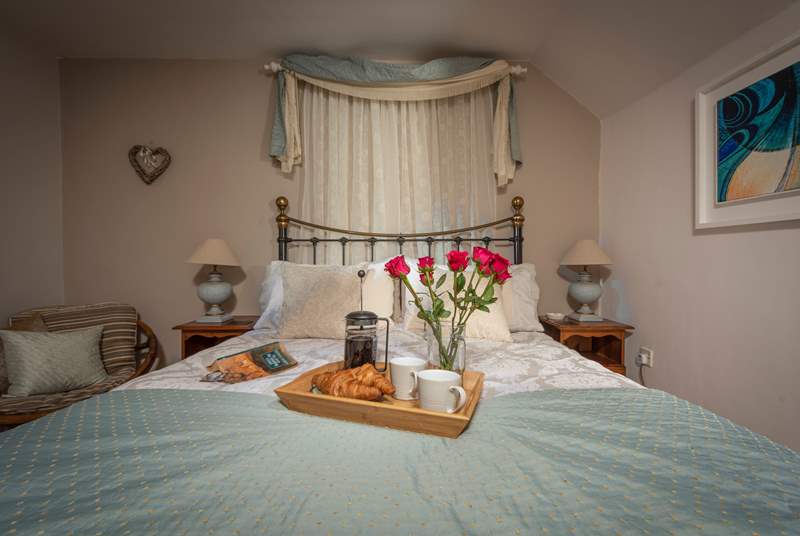 The spacious double bedroom has a king-size bed and gorgeous hand-made soft furnishings.