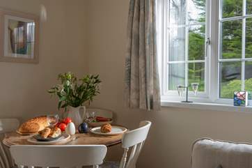 A dining-area with a lovely garden view.