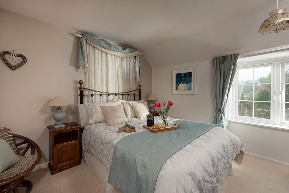The primary bedroom with king-size bed is beautifully furnished.