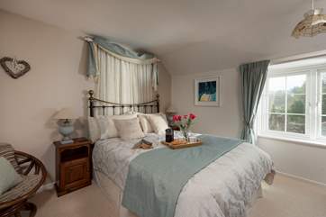 The main bedroom with king-size bed is beautifully furnished.