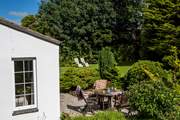 The mature gardens surround this pretty, private patio.