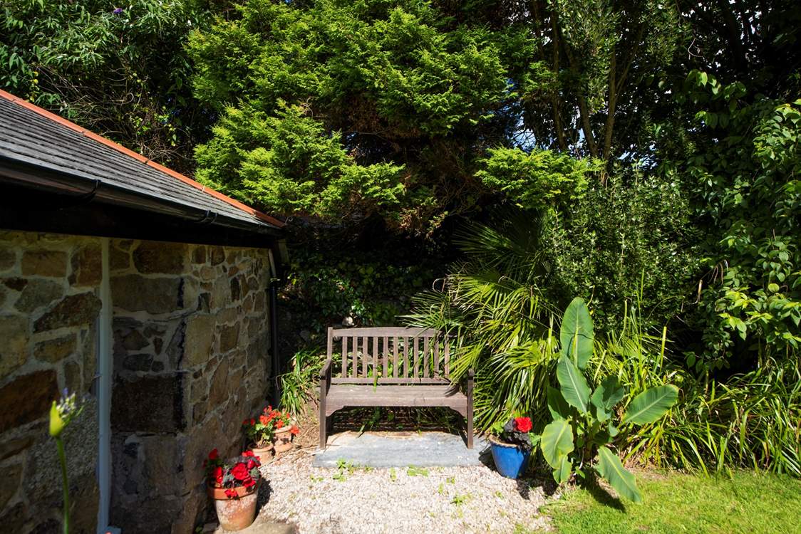 Relax on the garden bench with a morning coffee.