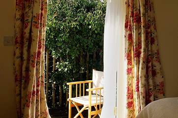 In the master bedroom patio doors lead out to the sunny deck-area.