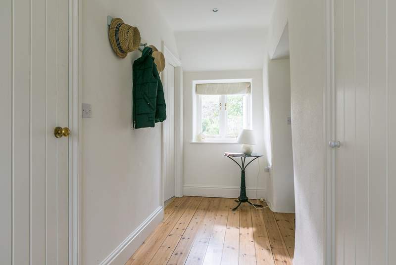 The bright and light hallway has plenty of room for all your coats, shoes, walking boots and more.