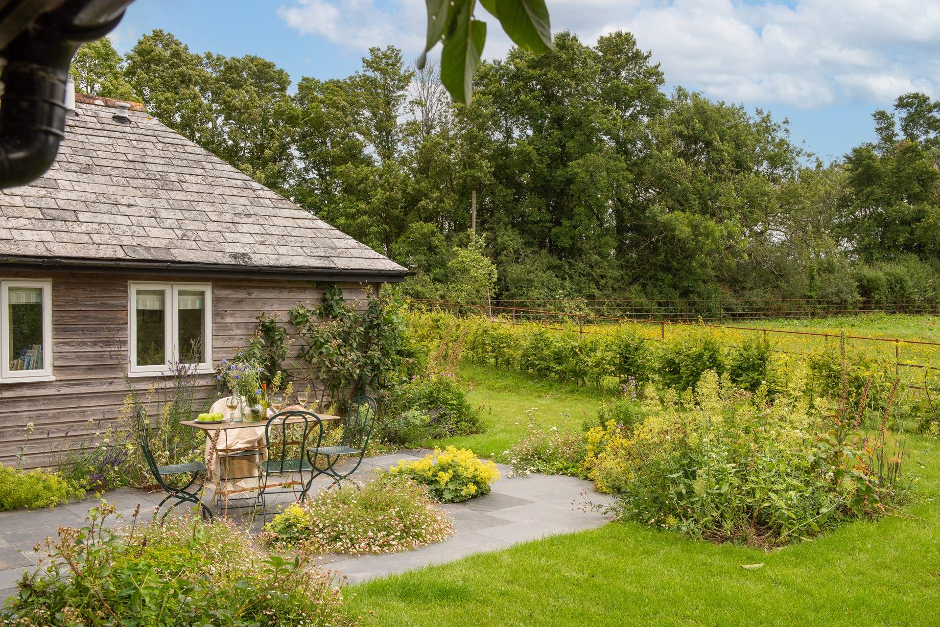 Enjoy alfresco dining in the sunny garden.