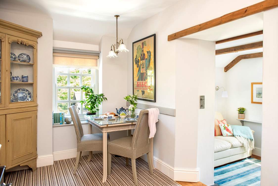 The charming dining area is beautifully furnished.