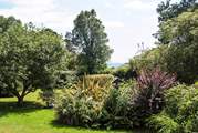 You can see the sea between the trees from the garden.
