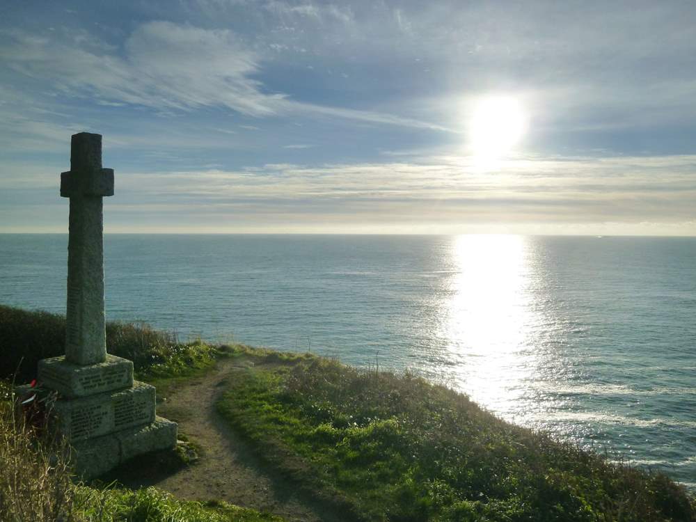 The Celtic cross on the clifftop at sunset.
