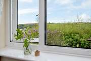 The second bedroom enjoys views of both the countryside and coastline.