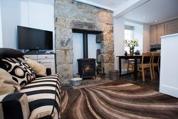 The sitting-area has a roaring wood-burner.