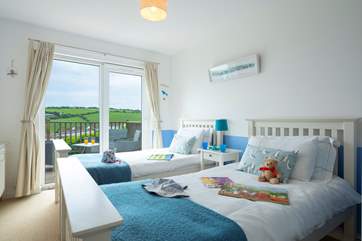 Bedroom 3 has twin 3' beds and patio doors onto the deck.