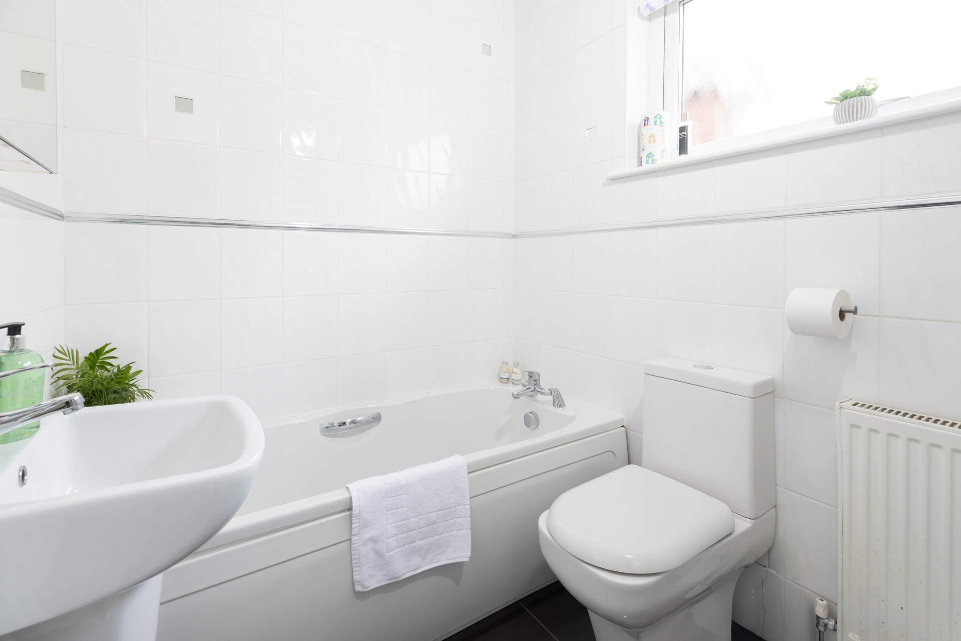 The family bathroom has a bath with separate shower cubicle. 