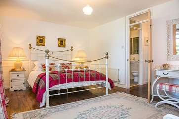 The master bedroom has a beautiful king size bedstead.