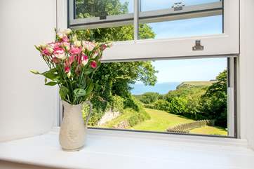 The master bedroom enjoys wonderful views over the garden and out to sea.