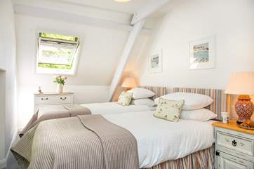 The twin bedroom with crisp white linens, gorgeous throws and cushions.