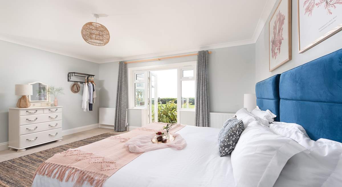 Bedroom One is wonderfully light and airy with double doors leading out to the garden.