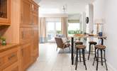 Leading off from the dining table is a little snug area and the breakfast bar. - Thumbnail Image