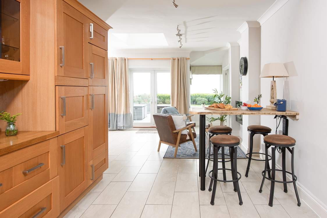 Leading off from the dining-table is a little snug area and the breakfast-bar.