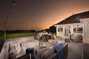 The festoon lights twinkle above the decking .