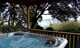 The hot tub looks out to the water. - Thumbnail Image