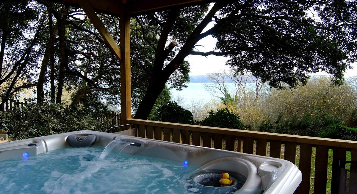 The hot tub looks out to the water.