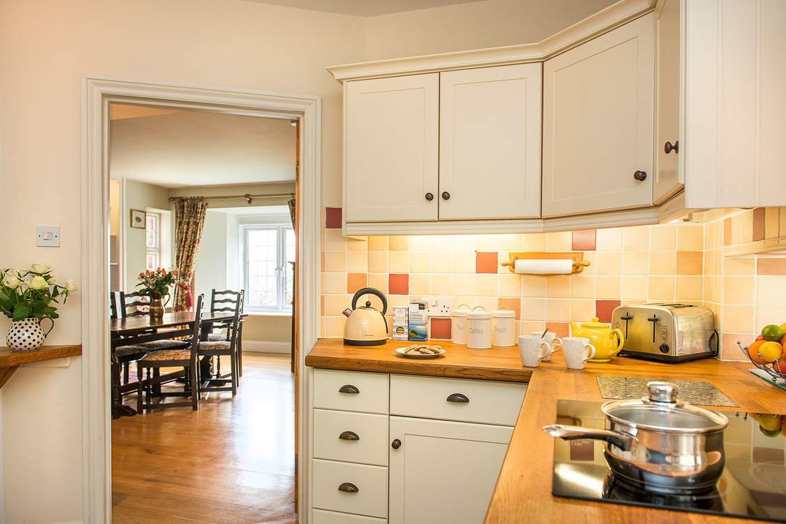 Beautiful wooden floors run from the kitchen through to the dining-room.