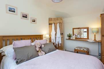The double bedroom has white bathrobes for your use.