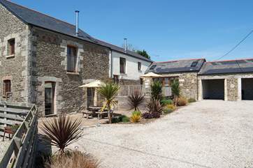 Each cottage has its own south-facing patio looking out over the shared lawn and countryside.